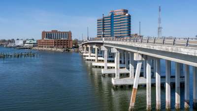 Hampton Harbor with a bridge and waterfront buildings on a clear day in Hampton, Virginia
