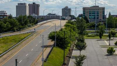 The downtown Newport News, Virginia skyline seen over a quiet roadway