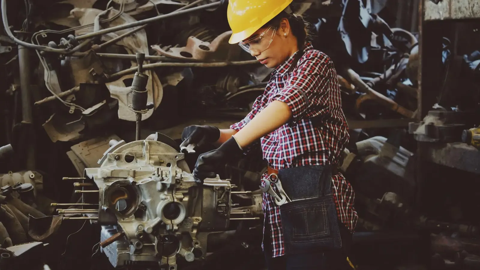 Welder working on a part on a light-manufacturing shop floor