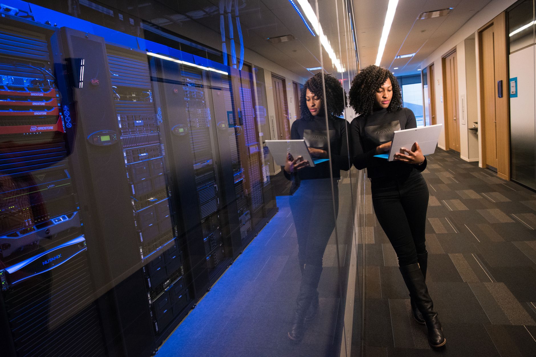 Small business owner reviewing cyber insurance application requirements with IT documentation